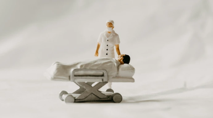 a toy of a person laying on a hospital bed